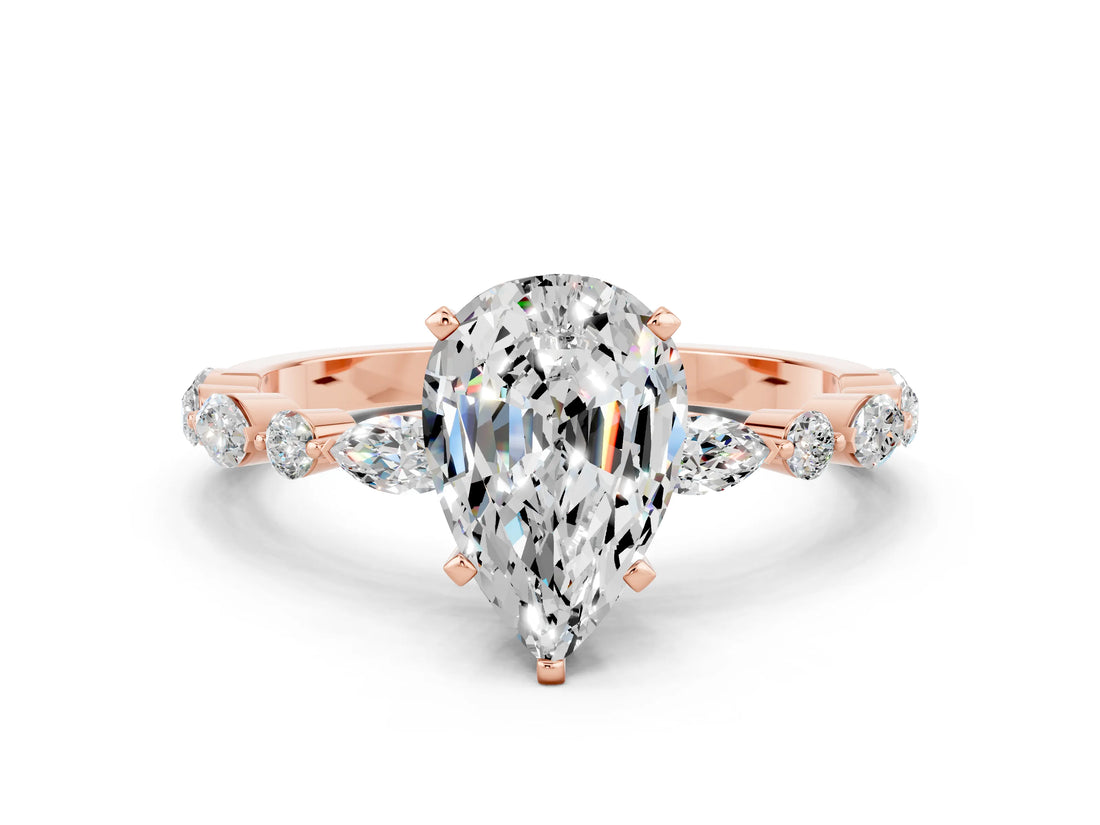 Rose gold Pear Cut Moissanite Solitaire with Side Stones on a Pavé Band and Four-Prong Setting