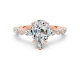 Rose gold Pear Cut Moissanite Solitaire with Side Stones on a Pavé Band and Four-Prong Setting
