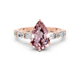 Rose gold Pear Cut Morganite Solitaire with Side Baguettes and Channel Set Band