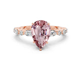 Rose gold Pear Cut Morganite Solitaire with Side Stones on a Pavé Band and Four-Prong Setting