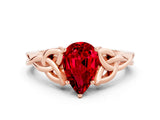 Rose gold Pear Cut Ruby Solitaire Engagement Ring with Celtic Knot Band and Four-Prong Setting
