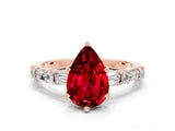 Rose gold Pear Cut Ruby Solitaire with Side Baguettes and Channel Set Band