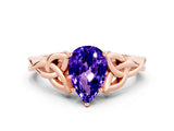 Rose gold Pear Cut Tanzanite Solitaire Engagement Ring with Celtic Knot Band and Four-Prong Setting