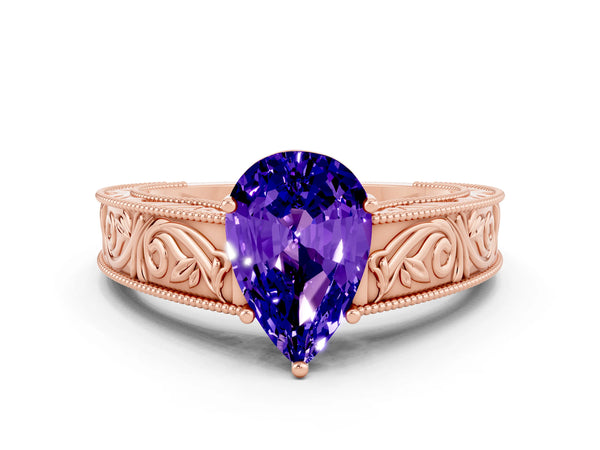 Rose gold Pear Cut Tanzanite Solitaire Ring with Engraved Band and Four-Prong Setting