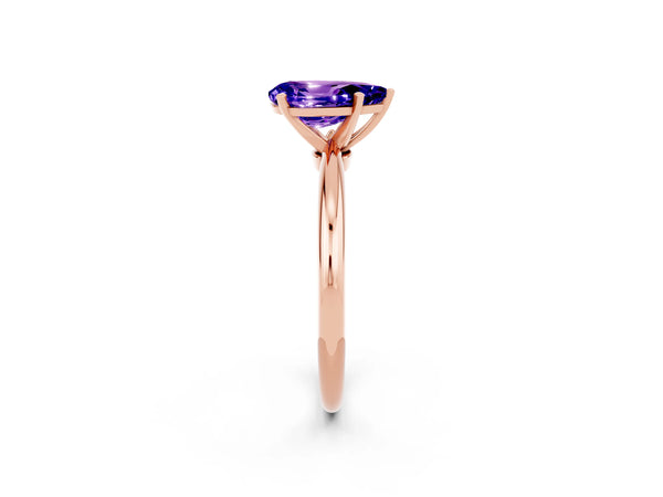 Rose gold Pear Cut Tanzanite Solitaire Ring with Six-Prong Setting and Classic Band