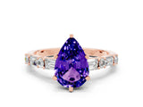 Rose gold Pear Cut Tanzanite Solitaire with Side Baguettes and Channel Set Band