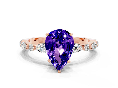 Rose gold Pear Cut Tanzanite Solitaire with Side Stones on a Pavé Band and Four-Prong Setting