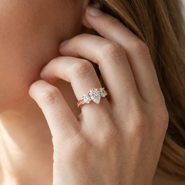 Rose gold Pear Diamond Three-Stone Ring with Prong Setting and Textured Band
