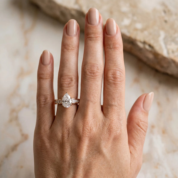 Rose gold Pear Solitaire Diamond Ring with Channel-Set Band and Four-Prong Setting