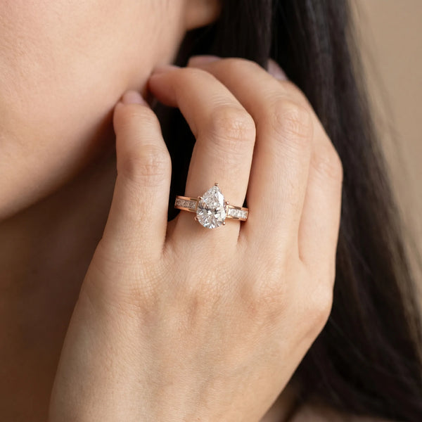 Rose gold Pear Solitaire Diamond Ring with Channel-Set Band and Four-Prong Setting