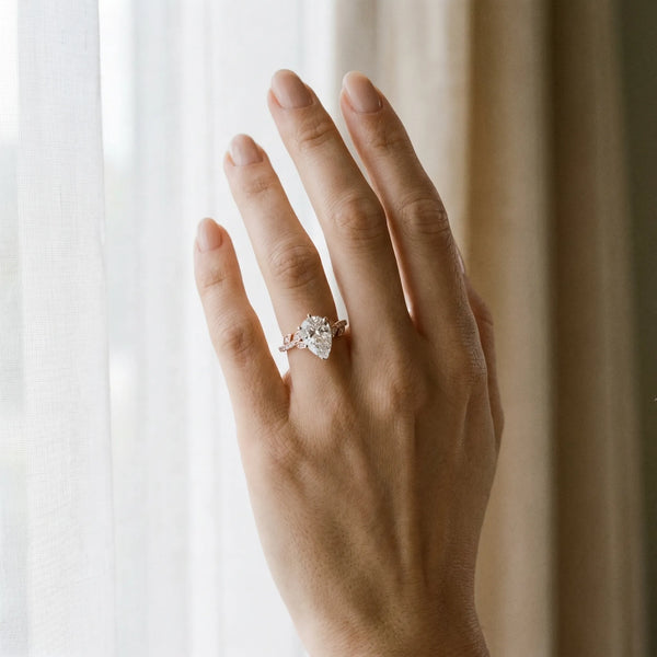 Rose gold Pear Solitaire Leaf-Inspired Diamond Ring with Pavé Band and Four-Prong Setting