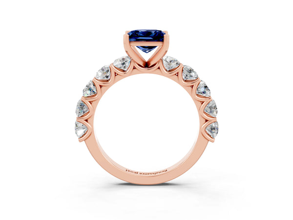 Rose gold Princess Cut Blue Sapphire Prong Setting with Side Stones on a Pave Band