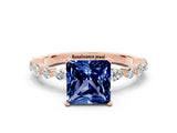 Rose gold Princess Cut Blue Sapphire Solitaire with Side Stones on a Pavé Band and Four-Prong Setting