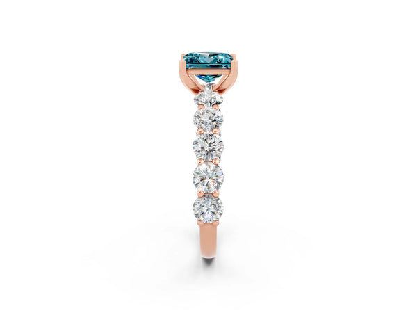 Rose gold Princess Cut Blue Topaz Prong Setting with Side Stones on a Pave Band