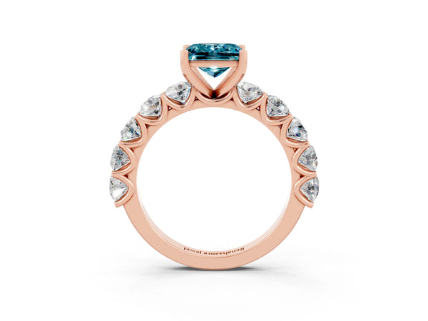 Rose gold Princess Cut Blue Topaz Prong Setting with Side Stones on a Pave Band