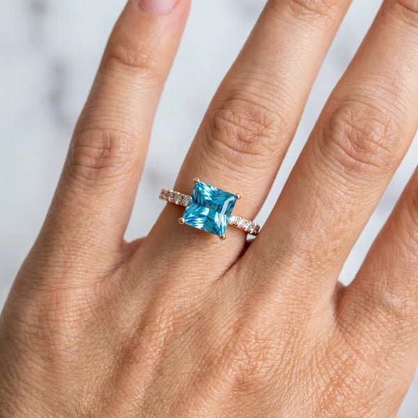 Rose gold Princess Cut Blue Topaz Solitaire Ring with Round  Pavé Band and Four-Prong Setting