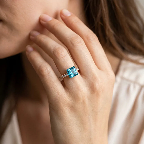 Rose gold Princess Cut Blue Topaz Solitaire Ring with Round  Pavé Band and Four-Prong Setting
