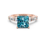 Rose gold Princess Cut Blue Topaz Solitaire with Side Baguettes and Channel Set Band