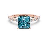 Rose gold Princess Cut Blue Topaz Solitaire with Side Stones on a Pavé Band and Four-Prong Setting