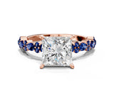 Rose gold Princess Cut Diamond Side Stone Solitaire Ring with Round with Blue Sapphire side stone and Four-Prong Setting