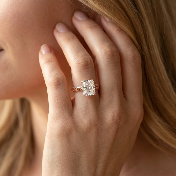 Rose gold Radiant Solitaire Engagement Ring with Scrollwork Band and Four-Prong Setting