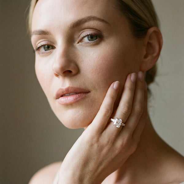 Rose gold Radiant Solitaire with Tapered Baguette Side Stones on a Classic Band with Four-Prong Setting