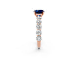 Rose gold Round Cut Blue Sapphire Prong Setting with Side Stones on a Pave Band_2