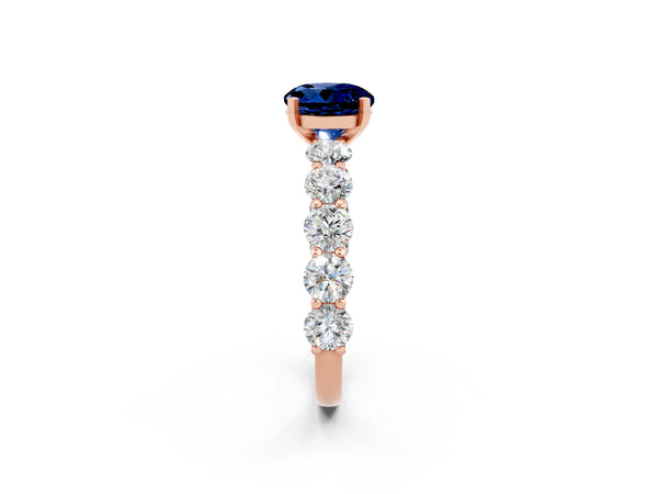 Rose gold Round Cut Blue Sapphire Prong Setting with Side Stones on a Pave Band