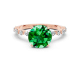 Rose gold Round Cut Emerald Solitaire with Side Stones on a Pavé Band and Four-Prong Setting
