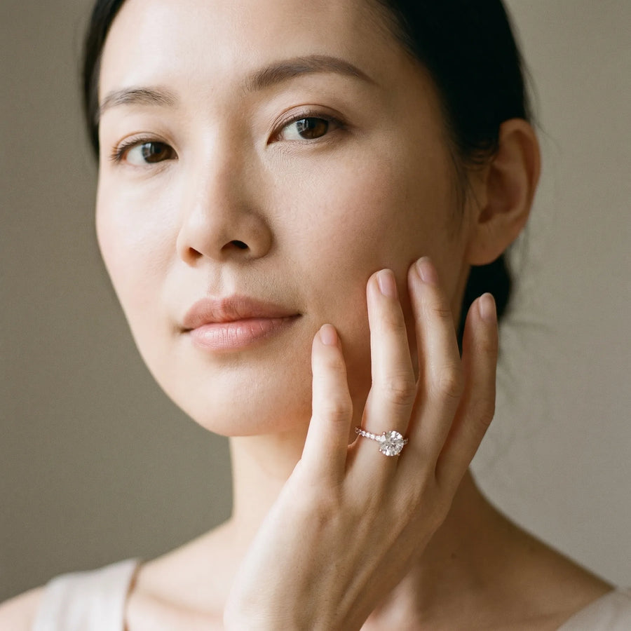 Rose gold Round Diamond Solitaire Ring with Four-Prong Setting and Pavé Band