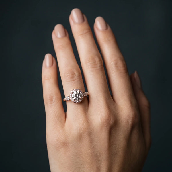 Rose gold Round Halo Three-Stone Diamond Ring with Pear Side Stones and Four-Prong Setting