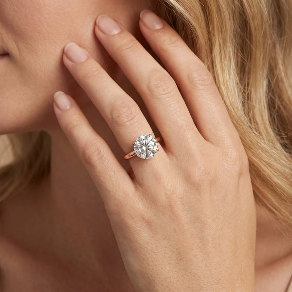 Rose gold Round Solitaire Diamond Engagement Ring with Four-Prong Setting on a Classic Band