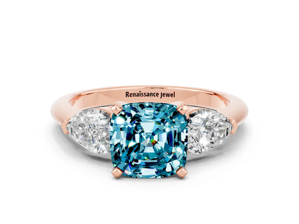 Rose gold Three-Stone Cushion Cut Blue Topaz Ring with Pear Side Stones and Four-Prong Setting
