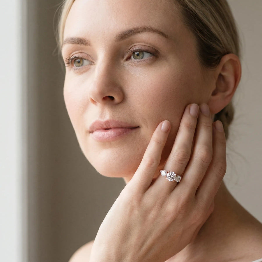Rose gold Three-Stone Cushion Diamond Engagement Ring with Prong Setting on a Classic Band