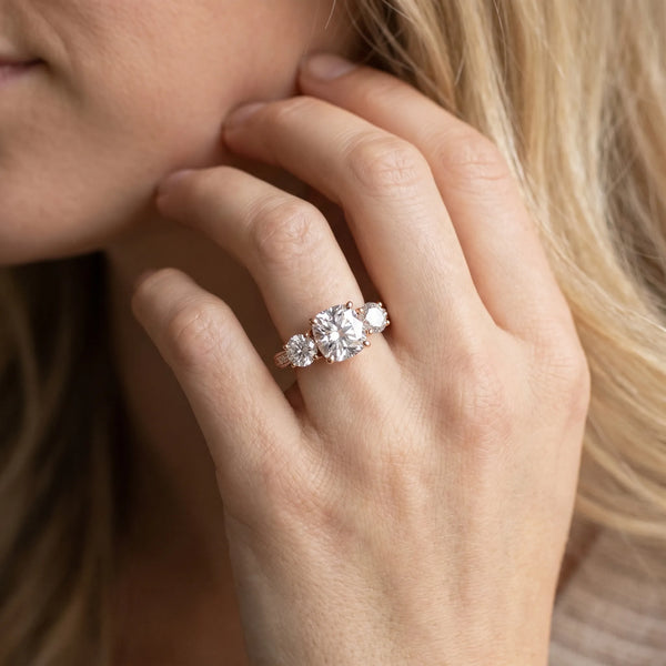 Rose gold Three-Stone Cushion Diamond Engagement Ring with Prong Setting on a Classic Band