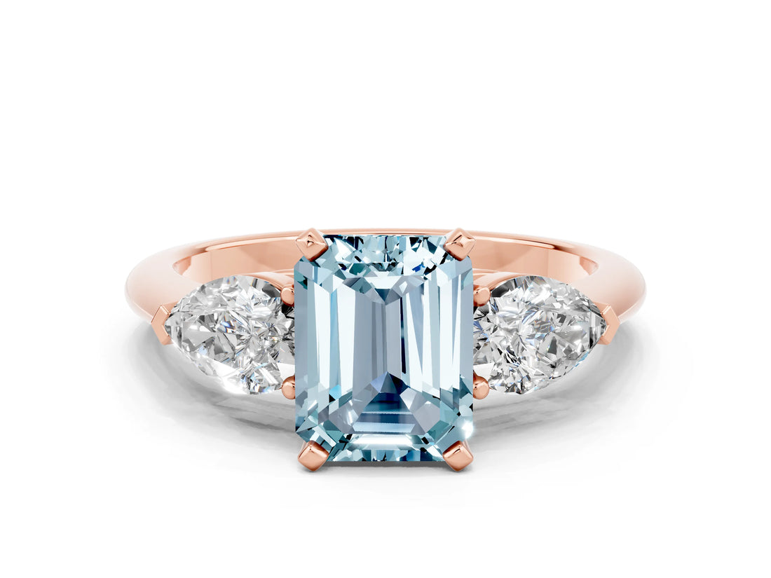 Rose gold Three-Stone Emerald Cut Aquamarine Ring with Pear Side Stones and Four-Prong Setting