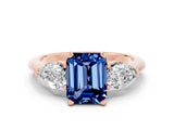 Rose gold Three-Stone Emerald Cut Blue Sapphire Ring with Pear Side Stones and Four-Prong Setting