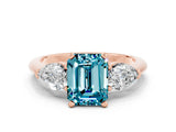 Rose gold Three-Stone Emerald Cut Blue Topaz Ring with Pear Side Stones and Four-Prong Setting