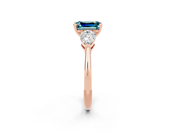 Rose gold Three-Stone Emerald Cut Blue Topaz Ring with Pear Side Stones and Four-Prong Setting