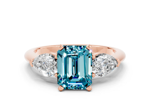 Rose gold Three-Stone Emerald Cut Blue Topaz Ring with Pear Side Stones and Four-Prong Setting