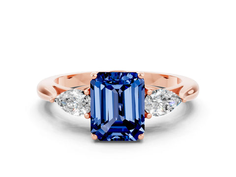 Rose gold Three-Stone Emerald Cut Cut Diamond Ring with Pear Side Stones in Four-Prong Setting
