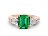 Rose gold Three-Stone Emerald Cut Cut Diamond Ring with Trillion Side Stones and Four-Prong Setting