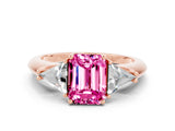 Rose gold Three-Stone Emerald Cut Cut Diamond Ring with Trillion Side Stones and Four-Prong Setting