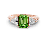 Rose gold Three-Stone Emerald Cut Cut Diamond Ring with Trillion Side Stones and Four-Prong Setting