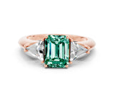 Rose gold Three-Stone Emerald Cut Cut Diamond Ring with Trillion Side Stones and Four-Prong Setting