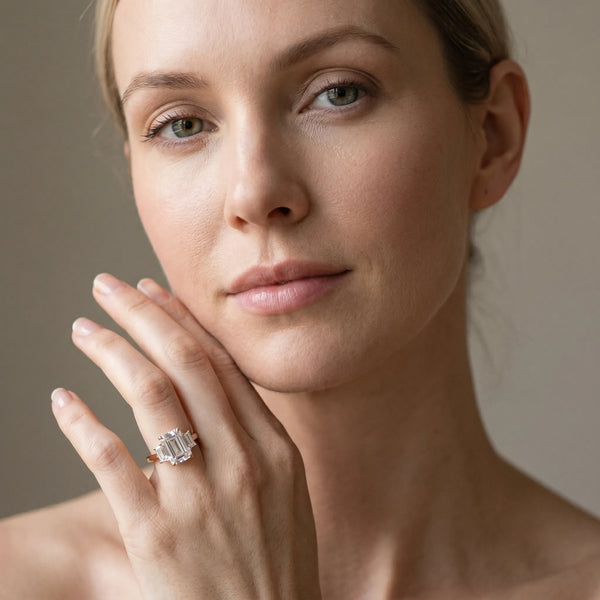 Rose gold Three-Stone Emerald Cut Diamond Engagement Ring with Prong Setting on a White Gold Band