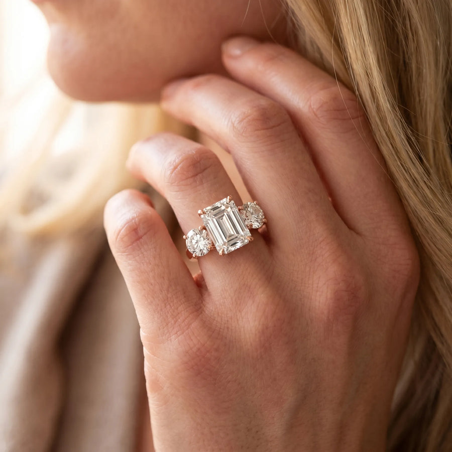 Rose gold Three-Stone Emerald Cut Diamond Engagement Ring with Prong Setting on a White Gold Band