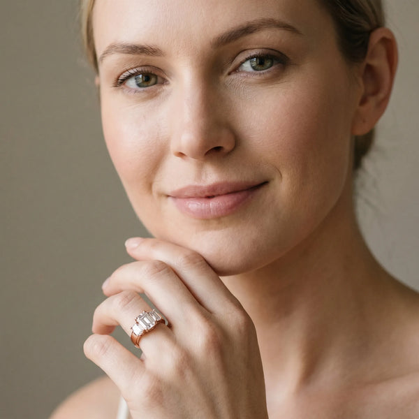 Rose gold Three-Stone Emerald Cut Diamond Ring with Channel Set Band and Four-Prong Setting