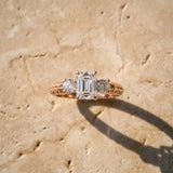 Rose gold Three-Stone Emerald Cut Diamond Ring with Channel-Set Band and Prong Setting_21