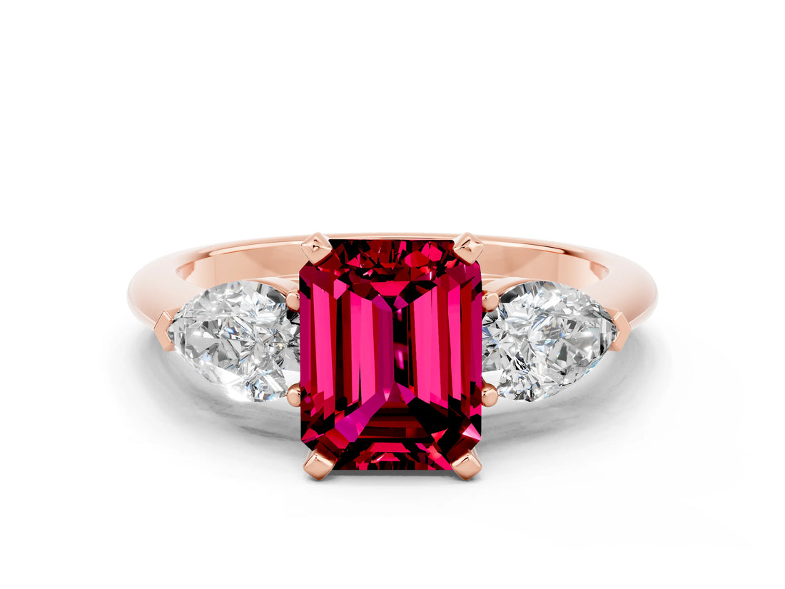 Rose gold Three-Stone Emerald Cut Garnet Ring with Pear Side Stones and Four-Prong Setting